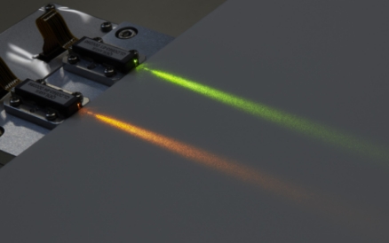 QD Laser’s 561nm (green) & 594nm (orange) compact visible lasers in a row, emitting the light of each color.